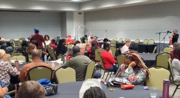 The NFB of Georgia members and guests seated at tables during a State Convention gathering.